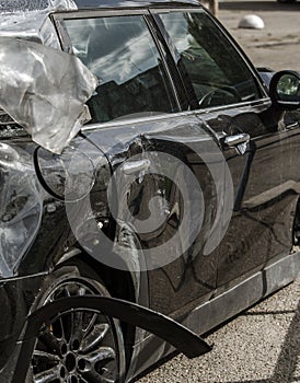 The body of the car is damaged as a result of an accident. High speed head on a car  traffic accident. Dents on the car body after