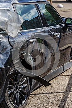 The body of the car is damaged as a result of an accident. High speed head on a car  traffic accident. Dents on the car body after