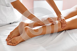 Body care. Close-up of woman getting spa treatment. Legs massage