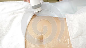 Body care concept. Rf skin tightening on female belly. Cosmetology procedure. Body contouring and cellulite reduction
