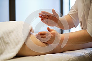 Body care concept. Special anticellulite treatment. Masseur makes anticellulite massage young woman in spa salon. Close