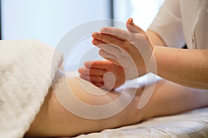 Body care concept. Special anticellulite treatment. Masseur makes anticellulite massage young woman in spa salon. Close