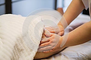 Body care concept. Special anticellulite treatment. Masseur makes anticellulite massage young woman in spa salon. Close