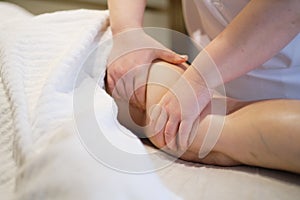 Body care concept. Special anticellulite treatment. Masseur makes anticellulite massage young woman in spa salon. Close