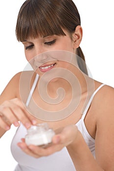 Body care - Female teenager applying moisturizer