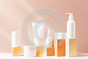 Body care products on the table, sunny composition with white containers and bottles