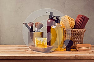 Body care products on wooden table over gray background