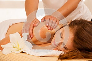 Body care. Spa body massage treatment. Woman having massage in t