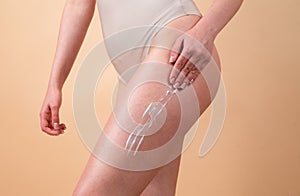 Body care. Woman applying cream on legs. Female applying anti cellulite cream. Cellulite or anti cellulite treatment