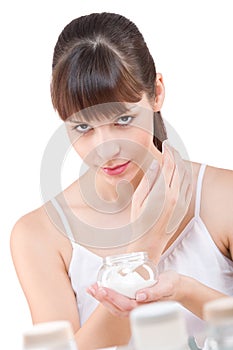 Body care: Woman with jar of moisturizer photo