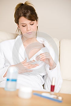 Body care - woman remove nail polish in bathrobe photo