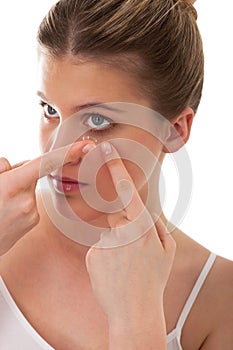 Body care - Young woman apply contact lens