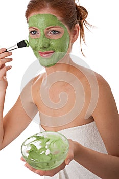Body care - Young woman apply facial mask