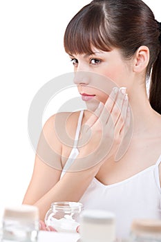 Body care: Young woman with jar of moisturizer