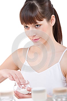 Body care: Young woman with jar of moisturizer