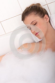 Body care - Young woman lie in the bathtub