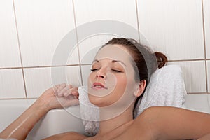 Body care - Young woman lie in the bathtub