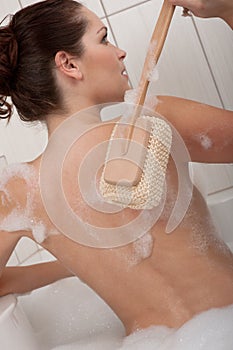 Body care - Young woman with sponge
