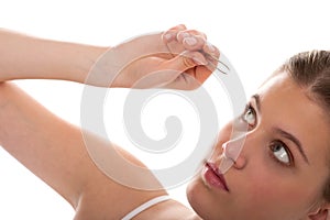 Body care - Young woman use tweezers
