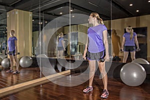 Body Conscious woman looking at herself in mirror