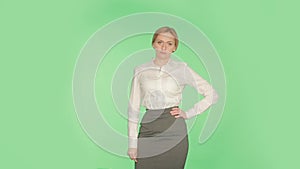 Body language. Beautiful blonde girl in a white blouse on a green background.