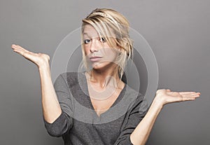 Body language concept for dubious 20s blond woman photo