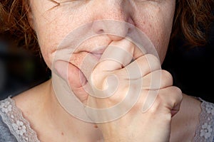 body language, hands near the face of a woman - a symbol of silence, forbidding yourself to say what you think, closeup