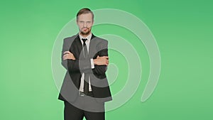 Body language. man in business suit . . crossed arms. green background, hromakey