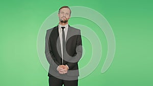 Body language. a man in a business suit on a green background