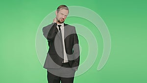 Body language. a man in a business suit on a green background