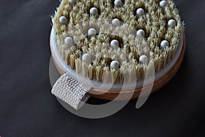 Body massage brush on a black background