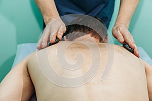 Body massage at physiotherapist office young man getting professional spine and back treatment