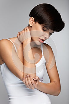 Body Pain. Beautiful Woman Feeling Pain In Elbows, Painful Arm photo