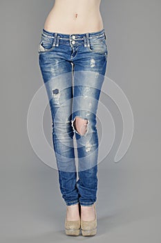 Body part, beautiful woman wearing jeans isolated on gray backgr