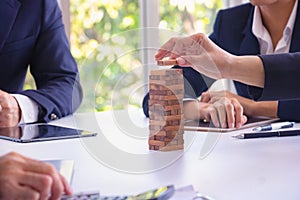 Body part Business engineers plays Jenga game and Orange hat. photo