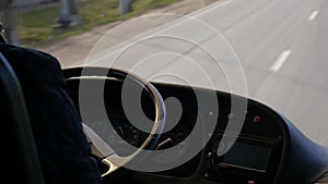 Body part man hands driving bus or truck. professional driver holding steering wheel in the car control machine motion view of onc