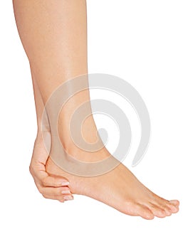 Body part of oman cares about her feet on white background