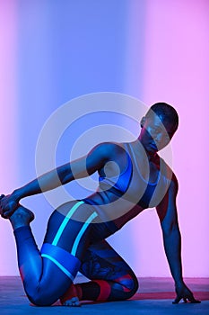 Body positive, slimming. African american woman in sportswear workout, fashion studio shot. Advertising photo, copyspace