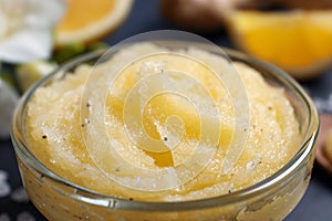 Body scrub in glass bowl on table, closeup