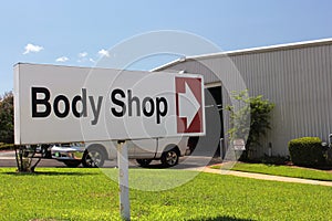 Body Shop Sign at Car Dealership Closeup on Sign