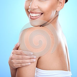 Body, skin and woman in studio for skincare, wellness and hygiene on blue background. Arm, profile and girl model relax