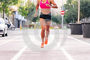 body of sportswoman running on the athletics track