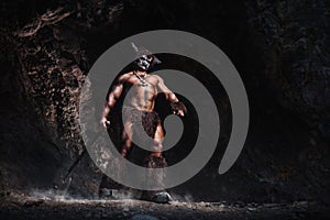 The bodyart man angry minotaur with axe in cave