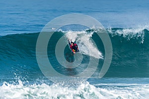 Bodyboarder surfing ocean wave