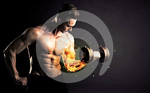 Bodybuilder athlete lifting weight with fire explode arm concept