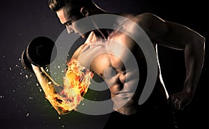 Bodybuilder athlete lifting weight with fire explode arm concept