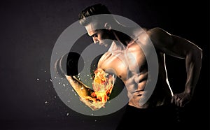 Bodybuilder athlete lifting weight with fire explode arm concept