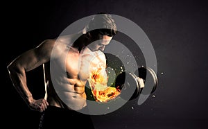 Bodybuilder athlete lifting weight with fire explode arm concept