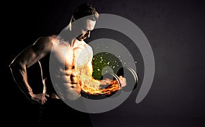 Bodybuilder athlete lifting weight with fire explode arm concept