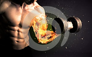 Bodybuilder athlete lifting weight with fire explode arm concept